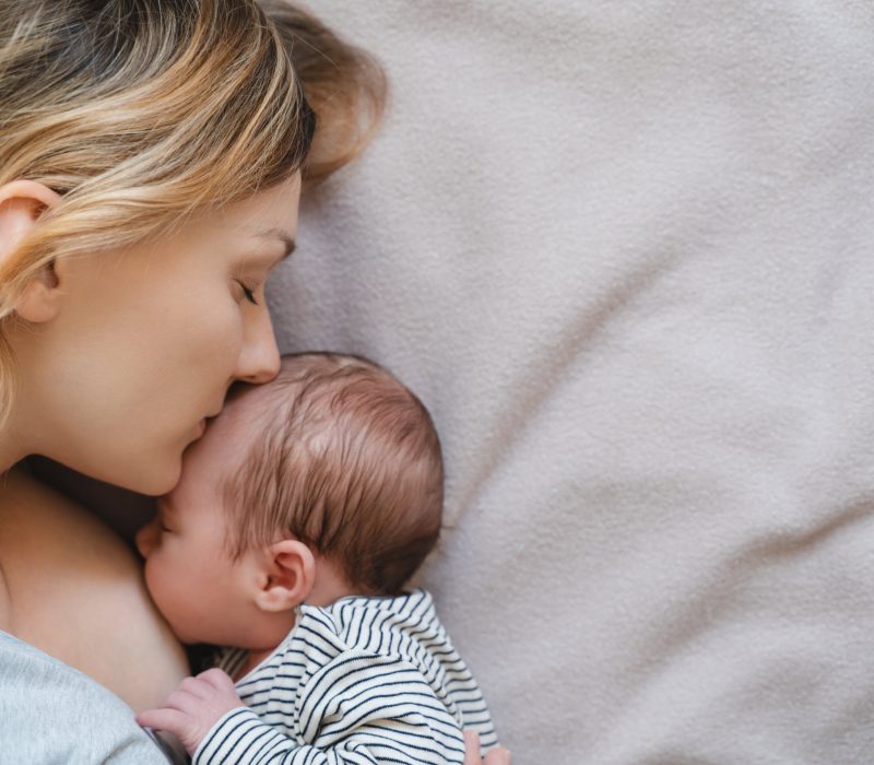 Mother breastfeeding baby. Concept of bonding mother and baby, healthy physical and mental development of child, natural parenting. Baby eating mother's milk. Woman nursing and feeding newborn baby.